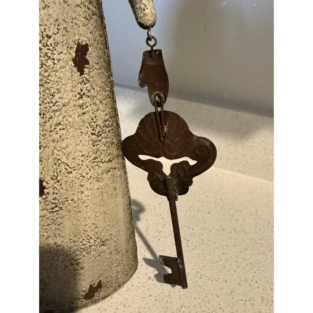 VTG decorative rustic metal sculpture of a stylized figure holding a large key.